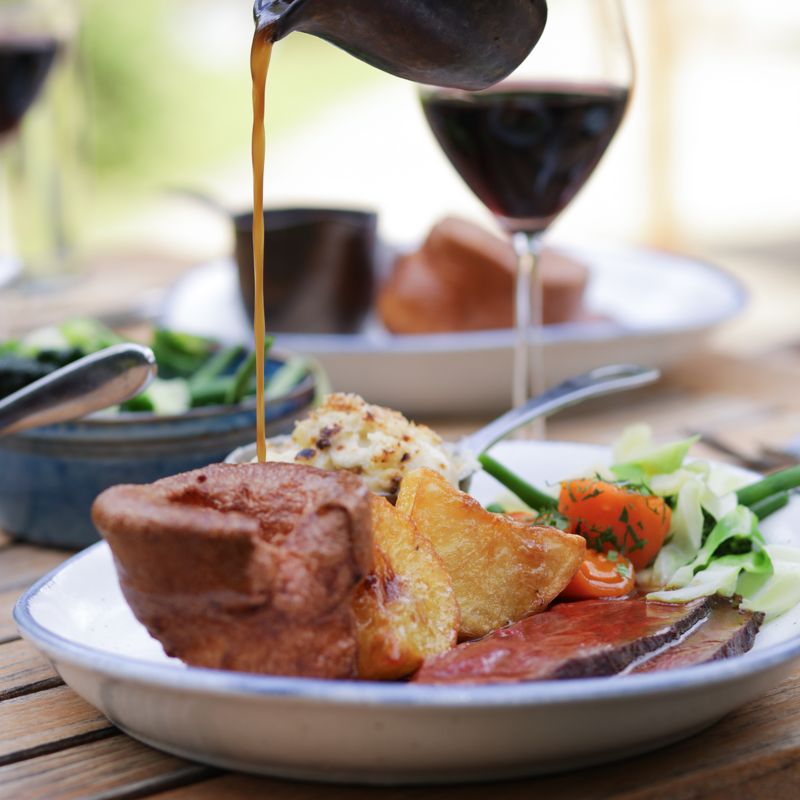Traditional Cotswold Sunday roast with roast beef and oversized Yorkshire pudding