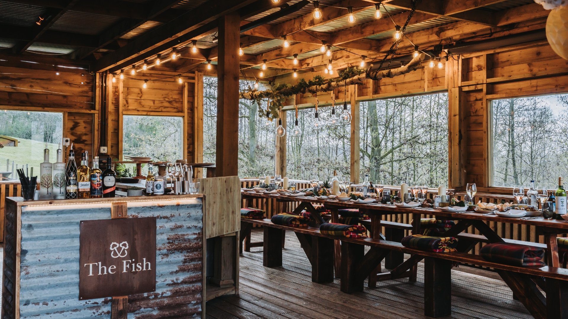 Chefs cooking over open flame grill on the Feasting Deck at The Fish Hotel