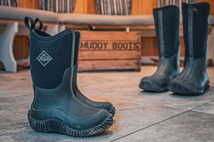 The Muck Boot Room at The Fish Hotel with rows of waterproof boots for guest loan