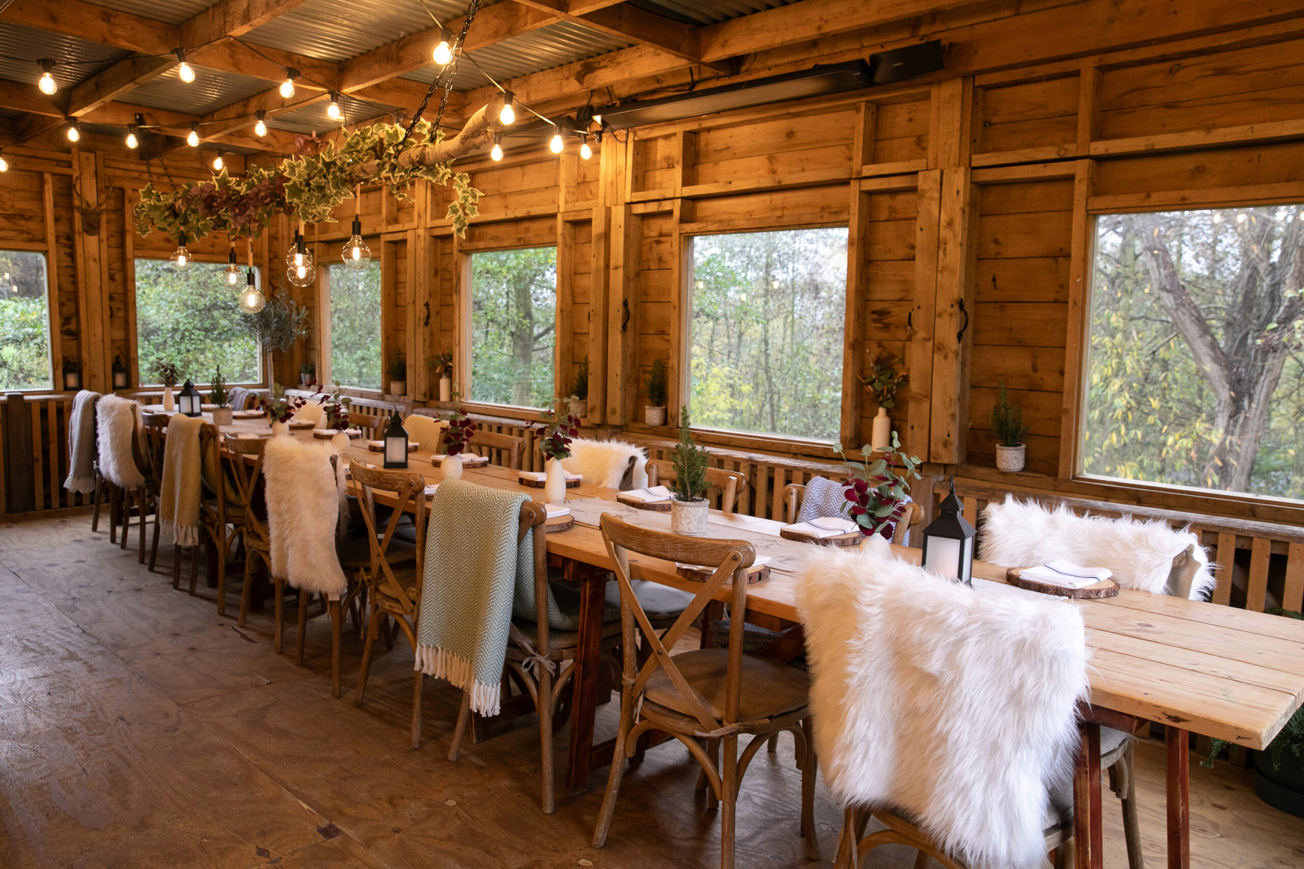 Diners gathered around communal dining table on the heated Feasting Deck
